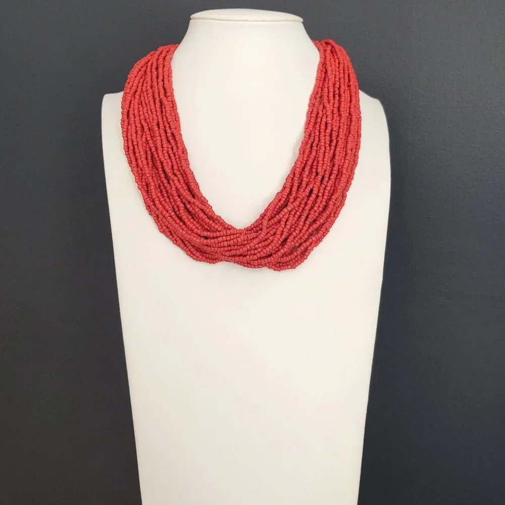 Layered orange beaded necklace with old coin toggle closure